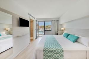 a hotel room with a bed and a tv at Calanova Sports Residence in Palma de Mallorca