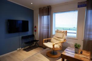 a living room with a chair and a television at Stave Camping in Stave