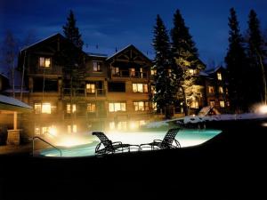 
a swimming pool with a balcony overlooking a lake at Mountain Thunder Lodge in Breckenridge
