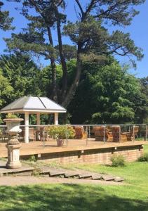 a gazebo with a table and chairs in a park at Penmorvah Manor Hotel in Falmouth