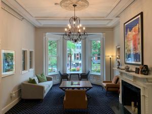 a living room with a chandelier and a fireplace at Newbury Guest House in Boston