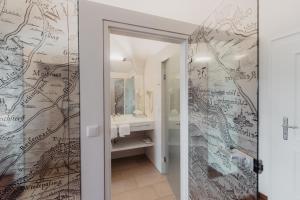 a bathroom with a wall mural of a map at Freigut Thallern in Gumpoldskirchen