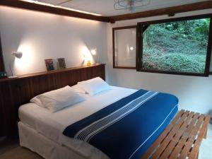 Cama ou camas em um quarto em O Sitio - Ilha Grande