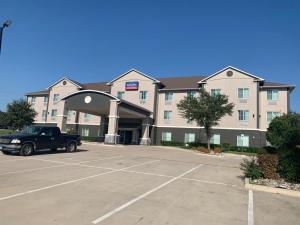 un hôtel avec un camion garé dans un parking dans l'établissement Executive Inn & Suites, à Marlin