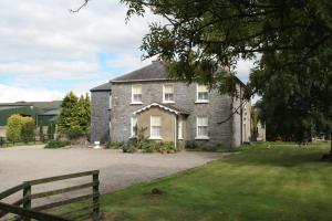a large brick house with a fence in front of it at Moate Lodge in Athy