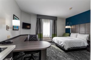 a hotel room with a bed and a desk at Candlewood Suites Knoxville Airport-Alcoa by IHG in Alcoa +20 photos
