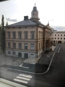 a large building with a clock tower on top of it at Market place Jakobstad Pietarsaari 53m2 in Pietarsaari