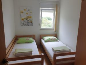two twin beds in a room with a window at Stella Maris in Kaštela +56 photos