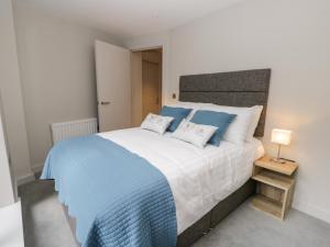 a bedroom with a large bed with two pillows at Leven View in Ulverston