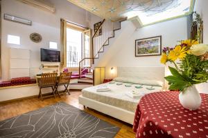 a bedroom with a bed and a staircase at Dei Medici Palace in Florence