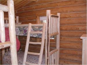 2 drewniane łóżka piętrowe w drewnianym domku w obiekcie Trails End Lodge w mieście Custer