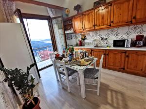 a kitchen with a white table and chairs and a window at Delphic Horizons in Delphi +37 photos