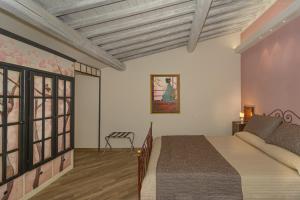Postel nebo postele na pokoji v ubytování Villa Agnolaccio Residenza d'Epoca