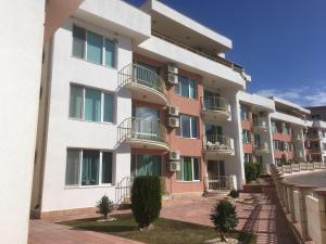 an apartment building with balconies on a street at Sea Paradise Apartment Complex in Kavarna
