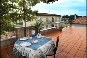 a table with a blue table cloth on a patio at Orange Garden in Minturno