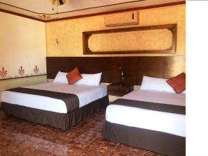 Ένα ή περισσότερα κρεβάτια σε δωμάτιο στο Hotel Tuul