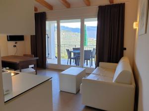 a living room with a couch and a table with a balcony at Villa Maria in Tremosine Sul Garda