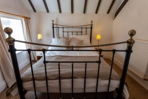 a black bed in a room with a window at Cliff House Holiday Cottages in Ebberston +138 photos