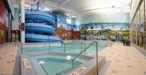 a large swimming pool with a slide in a building at Canad Inns Destination Centre Fort Garry in Winnipeg