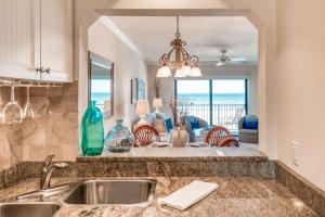 a kitchen with a sink and a view of a living room at Sunrise Terrace in St. Augustine