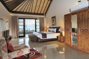 a bedroom with a bed and a living room at Destiny Villas and Residence in Seminyak