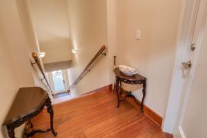 a room with a staircase and a table and a stair case at 110 St. George Street in St. Augustine