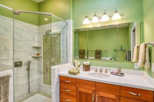 a green bathroom with a sink and a shower at St. George Street Apartment in Saint Augustine +37 photos