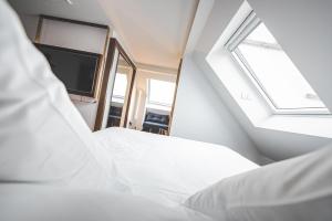 Cama ou camas em um quarto em Hotel Bernina Geneva