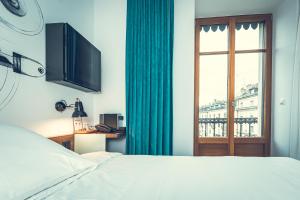 Cama ou camas em um quarto em Hotel Bernina Geneva