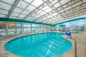 a large swimming pool with a glass ceiling at La Quinta by Wyndham Springdale in Springdale