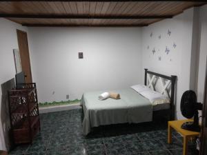 a bedroom with a bed and a television in it at Kitnet Rio Vermelho in Salvador