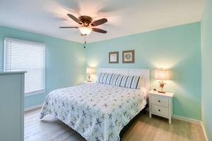 a bedroom with a bed and a ceiling fan at Seascape 2 in Saint Augustine