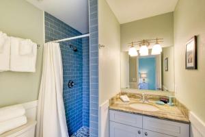 a bathroom with a sink and a shower at Seascape 2 in Saint Augustine +41 photos