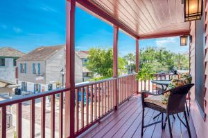 a porch with a chair and a view of the water at 64 Hypolita Street in St. Augustine