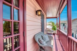 a porch with a chair and windows at 64 Hypolita Street in St. Augustine