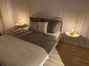 a bedroom with a bed with two side tables at Gemütliche Ferienwohnung für bis zu 6 Personen im Stadtzentrum in Bremerhaven