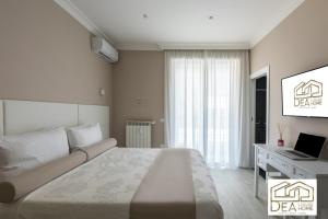 a bedroom with a bed and a desk with a laptop at Ponte Milvio Suite in Rome