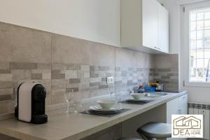 a kitchen with a counter with wine glasses on it at Ponte Milvio Suite in Rome