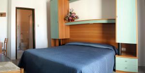 a bedroom with a blue bed in a room at Hotel Garden in Lignano Sabbiadoro