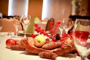 a table with fruits and vegetables on a table with glasses at Hotel Spies in Gladenbach