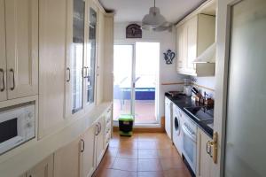 a kitchen with a sink and a dishwasher at Apartamento Las Infantas. Centro de Sanlucar. in Sanlúcar de Barrameda