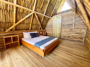 a bedroom with a bed and a wooden floor at Palomino Sunrise in Palomino