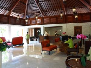 a lobby of a resort with people sitting in chairs at Griya Santrian a Beach Resort in Sanur