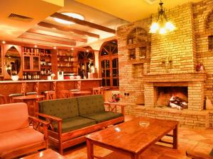 a living room with a couch and a fireplace at Spartacus House in Kalabaka