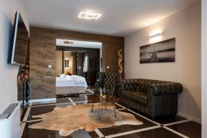 a living room with a couch and a bed at Suites Kod Guste in Sukošan