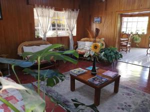 a living room with a table with a flower on it at Hotel Elohim by Rotamundos in Tequisquiapan
