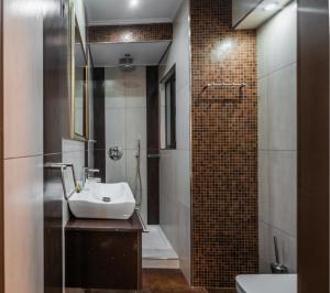 a bathroom with a sink and a shower at NOHO Boutique Koukaki , premium living in Athens