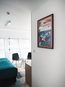 a bedroom with a picture hanging on the wall at Hotel Termalny in Uniejow