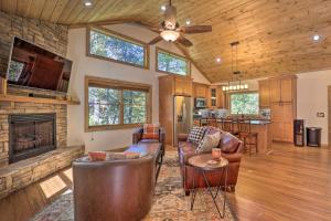 a living room with leather furniture and a fireplace at Treetop Cabin with Hot Tub, Near Appalachian Ski in Blowing Rock
