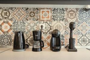 a kitchen counter with two coffee makers and a wallpaper at Bay View in Limenas